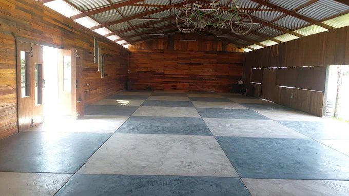 Salón amplio con techo de lámina y vigas
